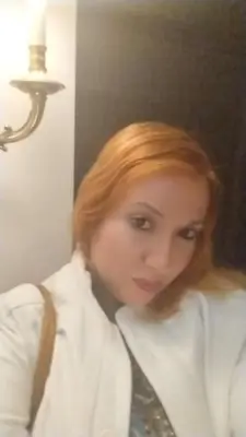 a woman with red hair wearing a white shirt and a tie at Al andalous in Marrakech