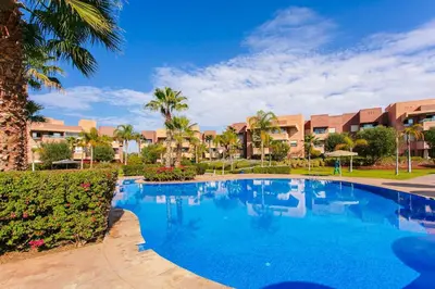 a large blue swimming pool in a resort at Your Tiny Paradise - Marrakech - Prestigia in Marrakech
