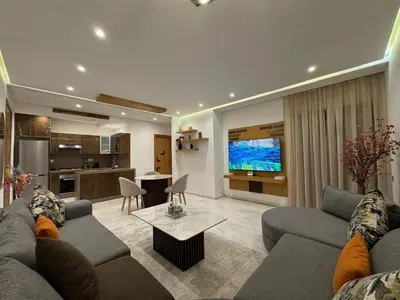 a living room with a couch and a tv at Chic 2BDR Apartment in Gueliz in Marrakech