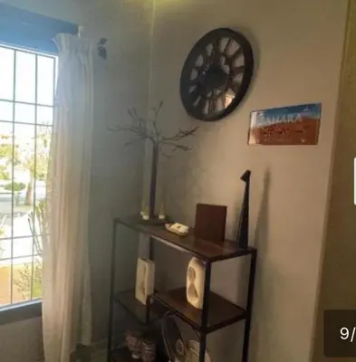 a room with a clock on the wall and a shelf at Mohsine in Marrakech