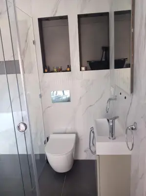 a white bathroom with a toilet and a sink at Mohsine in Marrakech