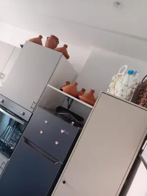 a kitchen with a refrigerator and a shelf at Mohsine in Marrakech