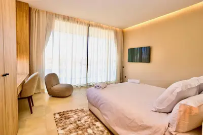 a bedroom with a large white bed and a window at Villa youngLA in Sehib Foukani