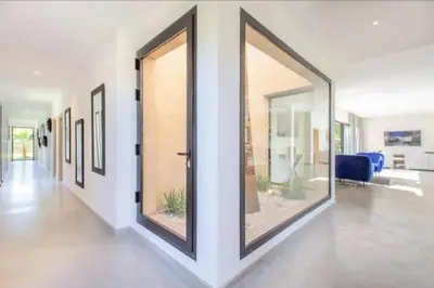 a hallway with large glass doors in a house at Villa Atlas piscine chauffee sans vis a vis in Marrakech