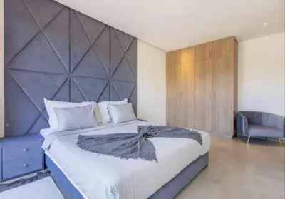 a bedroom with a large bed with a large headboard at Villa Atlas piscine chauffee sans vis a vis in Marrakech