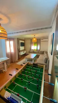 a living room with a pool table in the middle at Appartement Marrakech gueliz climatisé avec piscine et baby foot in Marrakech