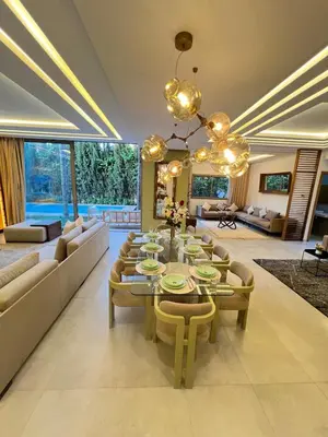 a large living room with a table and chairs at Villa Elixir , Luxury residence , private pool in El Rhechat