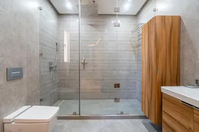a bathroom with a shower with a toilet and a sink at Villa Elixir , Luxury residence , private pool in El Rhechat