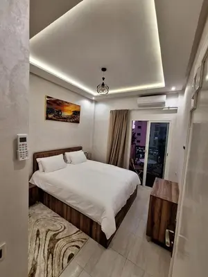 a bedroom with a large bed and a window at Charmant appartement proche du centre de Marrakech in Marrakech