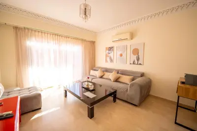 a living room with a couch and a coffee table at Luxury 2 BDRM in Hivernage with Pool and Garden in Marrakech