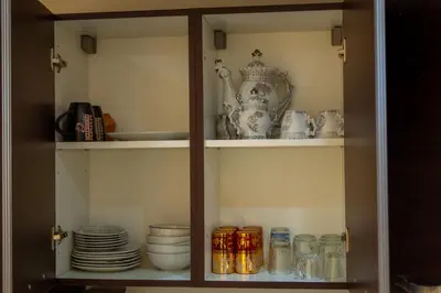 a cabinet filled with plates and other dishes at Luxury 2 BDRM in Hivernage with Pool and Garden in Marrakech