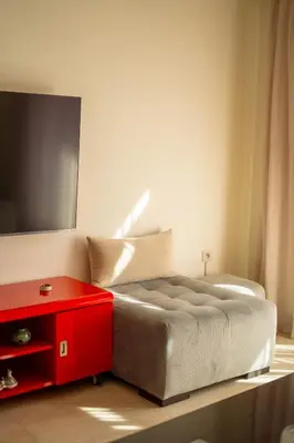 a bedroom with a bed with a red drawer and a tv at Luxury 2 BDRM in Hivernage with Pool and Garden in Marrakech
