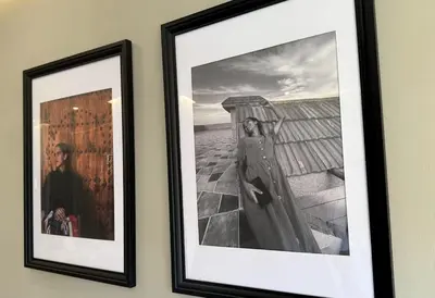 two framed photographs of a woman with an umbrella on a wall at Cosy Modern Apartment Central Gueliz Marrakech in Marrakech