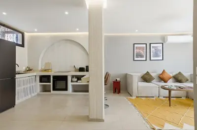 a white living room with a couch and a table at Cosy Modern Apartment Central Gueliz Marrakech in Marrakech
