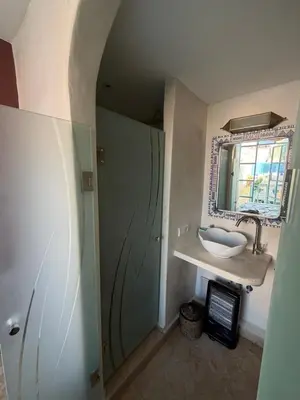 a bathroom with a sink and a mirror at La Petite Maison by Riad Dar Saad- Dar El Bacha in Marrakech