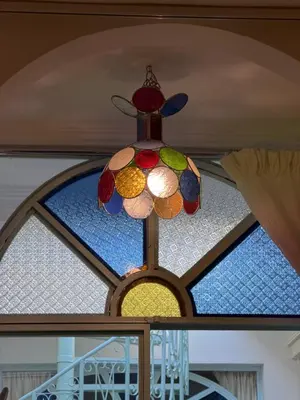 a stained glass chandelier hanging from a ceiling at La Petite Maison by Riad Dar Saad- Dar El Bacha in Marrakech