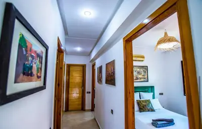 a bedroom with a bed and a hallway with a mirror at Appartement moderne Guéliz, Centre Marrakech in Marrakech