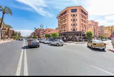 a city street with cars parked on the street at Cosy studio au cœur de Marrakech in Marrakech