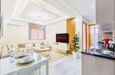 a kitchen and a living room with a couch at Cosy studio au cœur de Marrakech in Marrakech