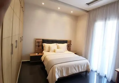 a bedroom with a large bed and a window at Villa Élégance Familiale in Marrakech