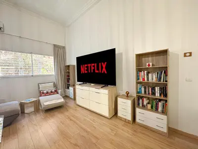 a living room with a netflix tv in the corner at Duplex Majorelle avec Jardin et Parking in Marrakech