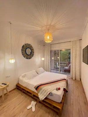 a bedroom with a large bed and a balcony at Green in majorelle in Marrakech