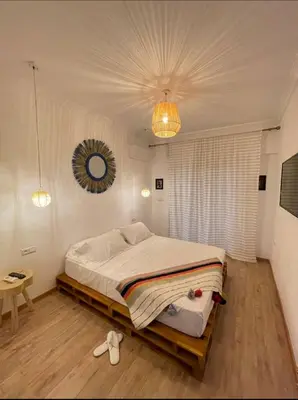 a bedroom with a bed and a mirror on the ceiling at Green in majorelle in Marrakech