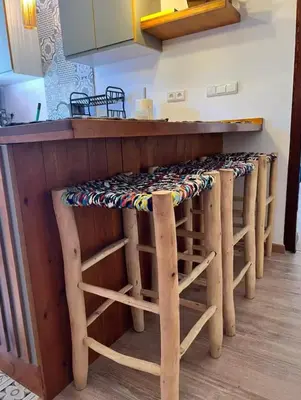 a bar with stools under a counter in a kitchen at Green in majorelle in Marrakech