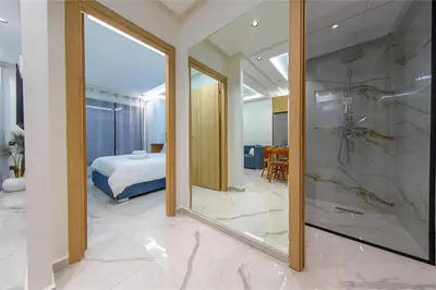 a bathroom with a shower and a bed and a mirror at Chic & comfort in the heart of Marrakech train station in Marrakech