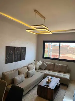 a living room with a couch and a table at Amazing well located appartement centre of marrakech near medina in Marrakech