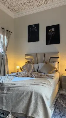 a bedroom with a large bed in a room at Riad Medina Palmeraie in Marrakech