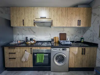 a kitchen with a stove and a washing machine at Modern & cozy 2 bedroom apartment in Marrakech