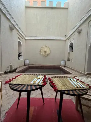 a room with two tables in a room at Riad Le Bijou de Zahra Marrakech Kasbah in Marrakech