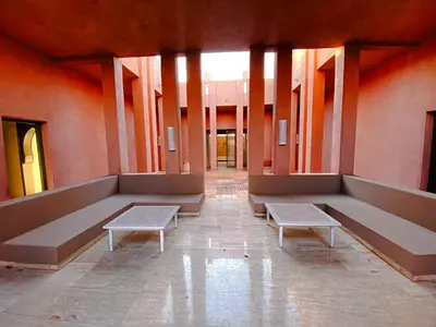 an empty hallway with benches in a building at Villa Moyen orient by séjour in Marrakech