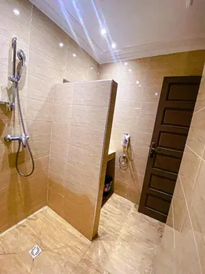 a bathroom with a shower with a glass door at Villa Moyen orient by séjour in Marrakech