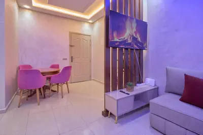 a living room with a table and a couch at Appartement l'aéroport in Marrakech
