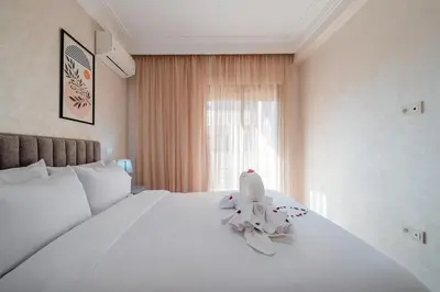a white bed in a room with a window at Comfort, ideal location in Guéliz Marrakech in Oulad Akkou