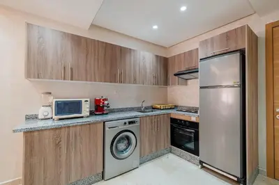 a kitchen with a refrigerator and a microwave at Comfort, ideal location in Guéliz Marrakech in Oulad Akkou