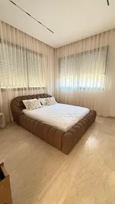 a large bed in a bedroom with curtains at Villa luxueuse in Marrakech