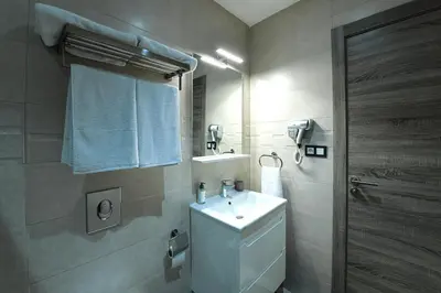 a bathroom with a white sink and a mirror at The Pearl Loft, Marrakech Luxury Apartment in Marrakech