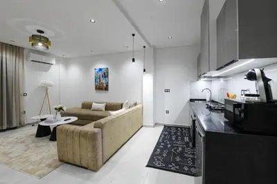 a kitchen and living room with a couch and a table at The Pearl Loft, Marrakech Luxury Apartment in Marrakech