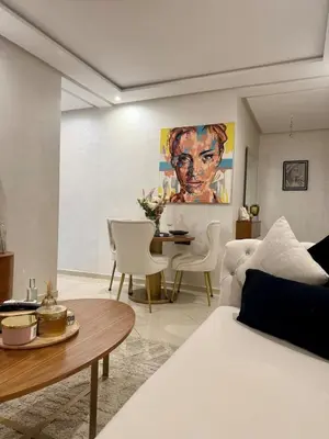 a living room with a white couch and a table at Modern charm in Marrakesh for a relaxing stay in Marrakech