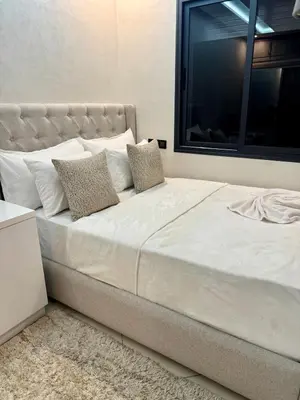 a large white bed with two pillows on it at Modern charm in Marrakesh for a relaxing stay in Marrakech