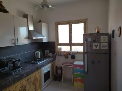 a kitchen with a refrigerator and a counter top at Appartement centre de Marrakech in Marrakech