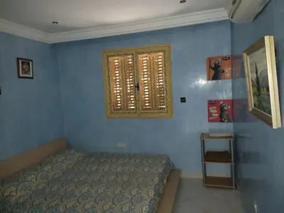 a bedroom with a bed and a window at Appartement centre de Marrakech in Marrakech