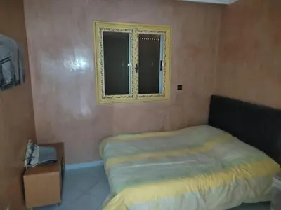 a small bedroom with a bed and a window at Appartement centre de Marrakech in Marrakech