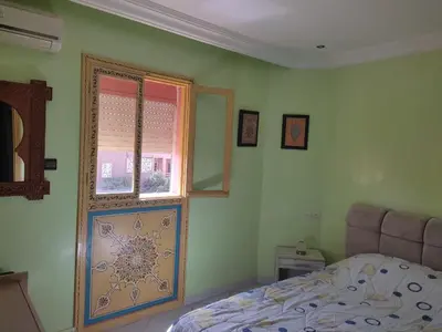 a bedroom with a bed and a window at Appartement centre de Marrakech in Marrakech