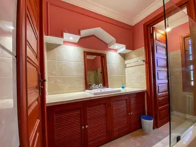 a bathroom with a sink and a mirror at Villa Dar Zitoune in Marrakech
