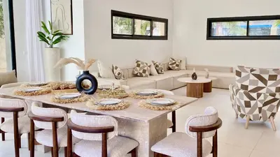a living room with a table and chairs at Villa de Rêve sans vis-à-vis à Marrakech in Marrakech