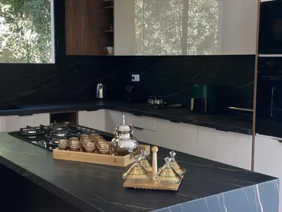 a kitchen with a black counter top with a stove at Villa de Rêve sans vis-à-vis à Marrakech in Marrakech
